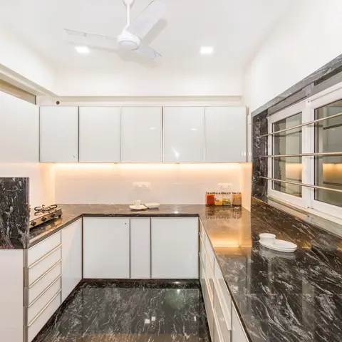 black and white modern minimalist kitchen with shutter — real Indian home