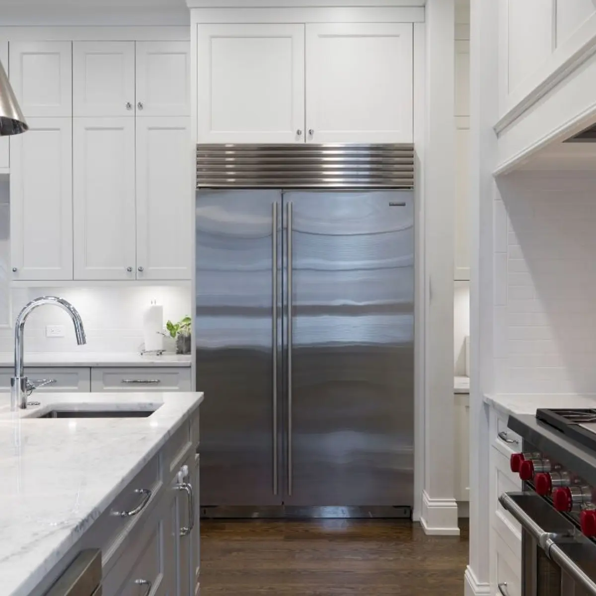 White shaker kitchen with a marble waterfall island