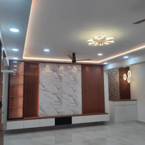 Handover photo of an empty living room's feature wall: a white marble-look slab panel flanked by fluted and plain wood veneer, a floating white console below