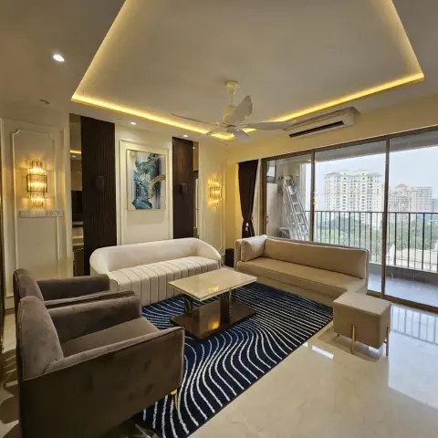 High-rise living room with a cove-lit ceiling, polished marble flooring, a navy wave-pattern rug