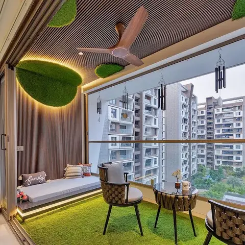 Home balcony with artificial-turf flooring, a wood-slat ceiling with backlit moss art discs, a built-in cushioned daybed