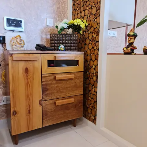 Home entrance foyer with a solid pine wood storage console topped with a video door phone, a Ganesh idol and a flower vase