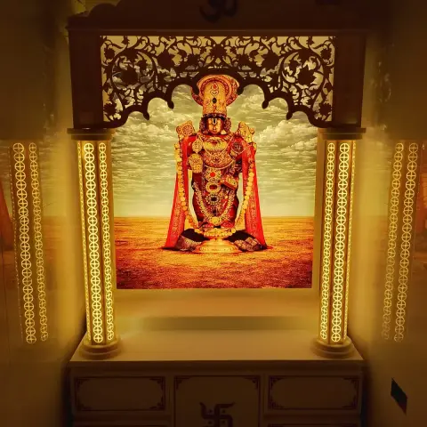 Home mandir with turned columns lit from within through CNC-cut acrylic strips, a scalloped floral jaali valance and an Om crest above a printed Balaji