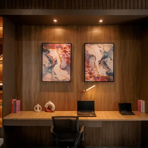 Home study nook with a floating wood desk built into slatted wood panelling, gallery-lit abstract art