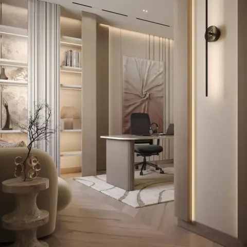 Home study seen through a doorway: a fluted cream desk and black task chair on a swirl-pattern rug, a draped-fabric artwork on the fluted panelled wall behind