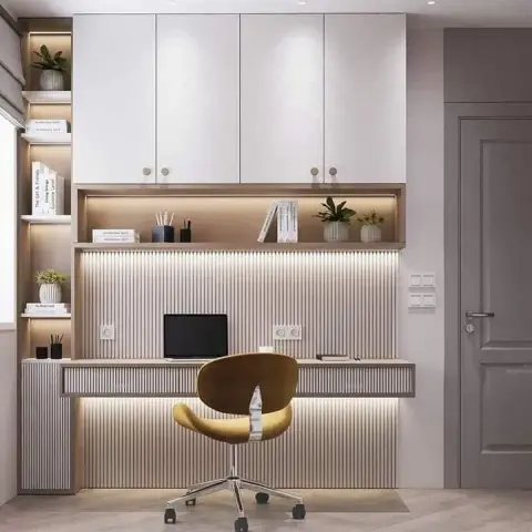Home-study wall of fluted beige panelling with a cantilevered oak writing ledge lit by LED strips above and below
