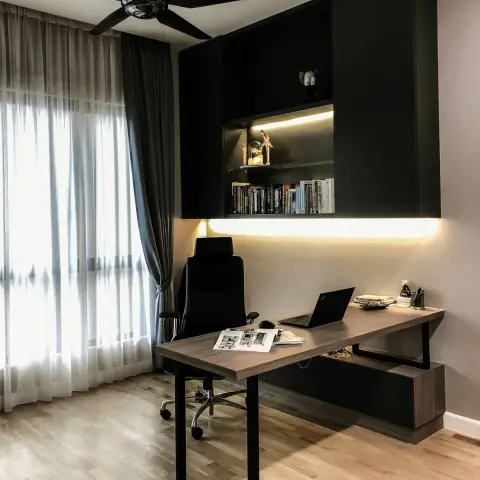 Home study where a matt-black overhead storage box with one lit book shelf hangs above a walnut desk on black U-frame legs