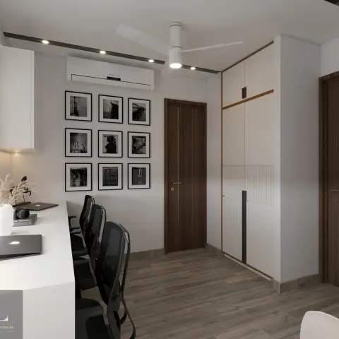 Home study with a long built-in white desk, black mesh office chairs, a nine-panel black-and-white photography gallery wall