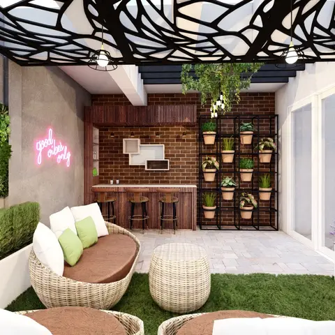Home terrace lounge with rattan seating on artificial turf, a mini bar against exposed brick, a vertical living wall and a neon sign under a laser-cut canopy