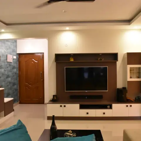 Indian living room with a wenge-and-white laminate TV unit under a loft display shelf