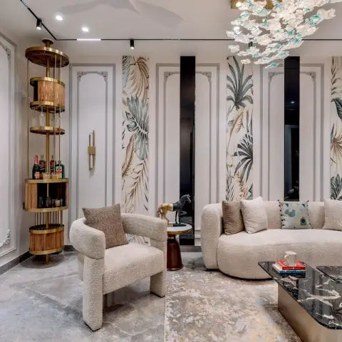 Ivory boucle curved sofa and armchair around a black marble and brass coffee table