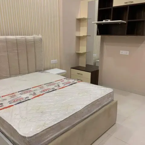 Just-handed-over bedroom where the mattress is still sealed in its printed factory wrapping