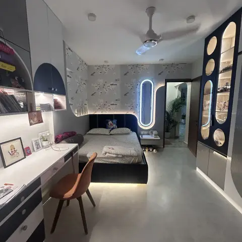 Kids' bedroom papered in vintage aeroplanes and world maps: navy storage bed with an under-bed LED glow and a backlit oval mirror beside it