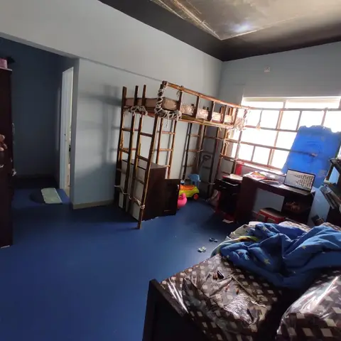 Kids' bedroom with a blue rubber-tile floor, a painted space-themed ceiling mural, a wood climbing and loft play structure