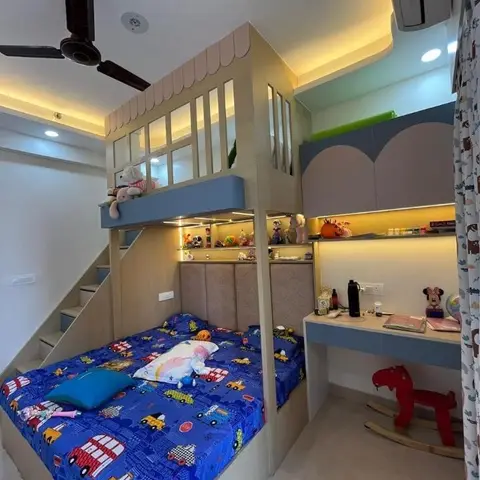 Kids' bedroom with a custom loft playhouse bed over a storage staircase, a wall-mounted study desk, and cloud-shaped overhead cabinets.