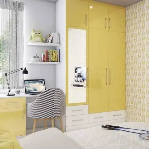 Kids' bedroom with a glossy yellow wardrobe and built-in study desk, a leaf-print wallpaper accent wall, and open shelving styled with books and a plush owl.