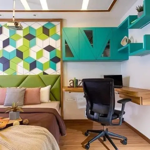 Kids' bedroom with a green upholstered headboard below a geometric hexagon-tile accent wall and a teal floating study desk with cubby shelving.