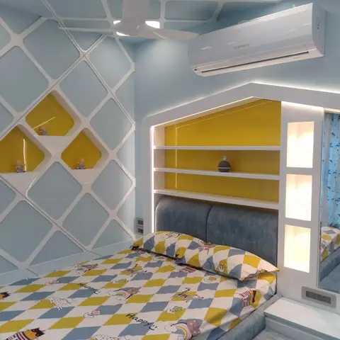 Kids' bedroom with a house-shaped illuminated yellow headboard shelving unit and a blue diamond-pattern 3D wall panel.