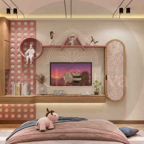 Kids' bedroom with a pink perforated-panel display wall around the TV unit, a scalloped pink wardrobe, and a stuffed toy on a dusty-rose bed.