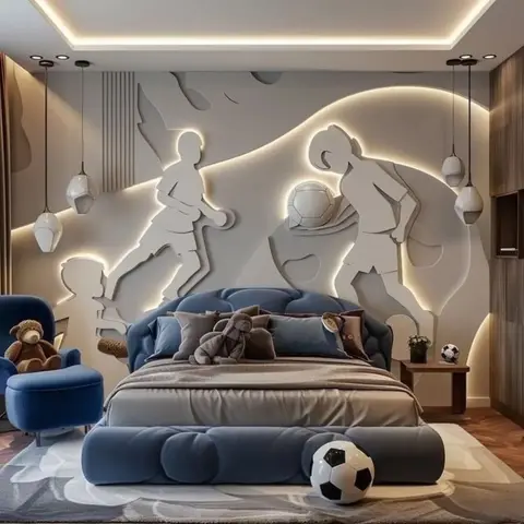 Kids' bedroom with a tufted navy bed, a backlit 3D football-player relief wall mural, matching pendant lights, and a velvet armchair with a teddy bear.