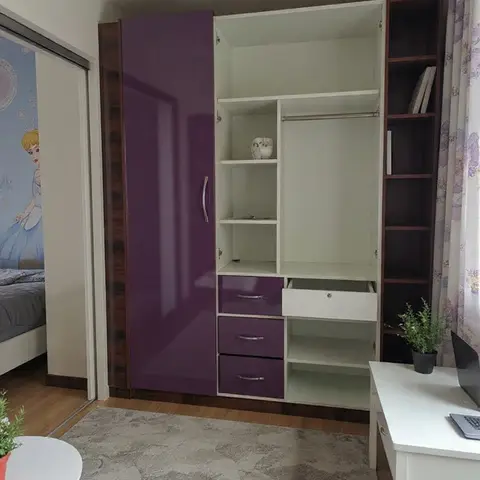 Kids' room with a purple and white gloss open wardrobe featuring drawers and a side ladder shelf