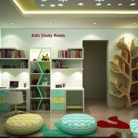 Kids' study room with a mint and yellow built-in desk with open shelving, a tree-shaped wall bookshelf, a star-pattern backlit false ceiling