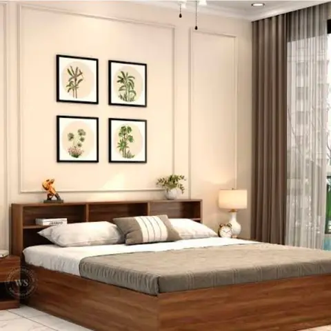 King bed with a built-in storage headboard beneath a four-panel botanical gallery wall, flanked by matching lamps and floor-to-ceiling taupe curtains.
