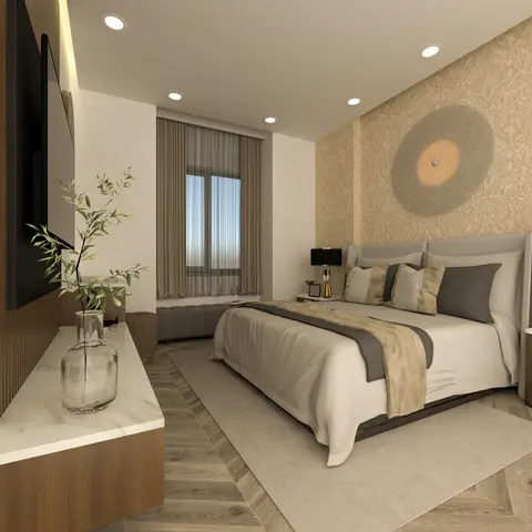 King bed with a grey upholstered headboard set against a gold medallion-patterned wallpaper wall