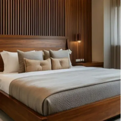 King bed with a solid wood platform frame set against a fluted wood-slat wall with a hanging pendant light beside the nightstand.