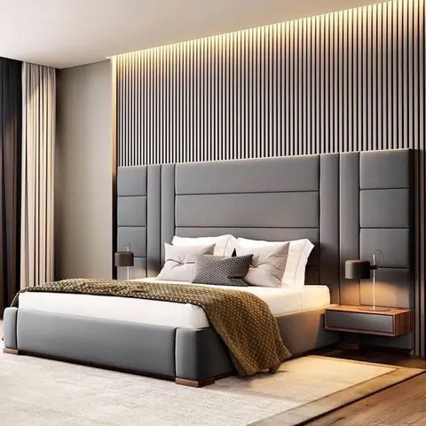 King bed with a tall channel-tufted grey headboard against a backlit vertical-slat wood accent wall, flanked by floating walnut nightstands with pendant lamps.
