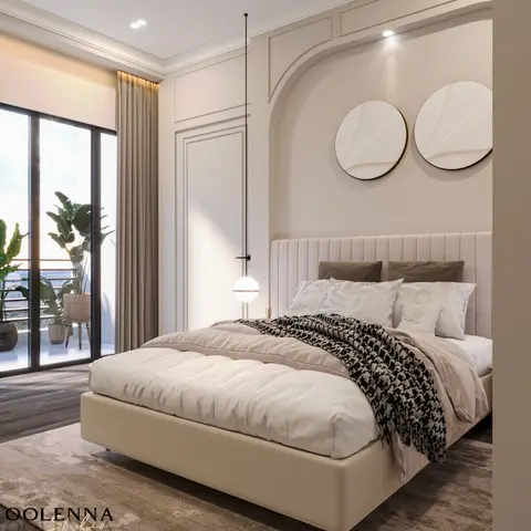 King bedroom with a channel-tufted headboard set in an arched moulded wall niche, twin circular textured wall discs, and a glazed balcony with potted plants.