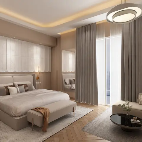 King bedroom with a fluted stone-textured headboard wall, herringbone wood flooring, and an adjoining sofa sitting area beside floor-to-ceiling curtains.