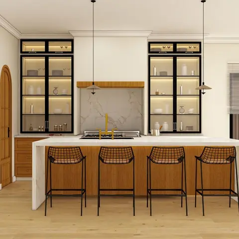 Kitchen island with a waterfall marble countertop and gold cooktop fittings, flanked by black-framed glass display cabinets with warm interior lighting.