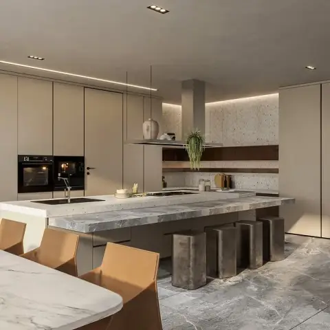 Kitchen with a long grey marble-topped island, metal bar stools and a terrazzo feature wall, with a marble dining table and tan leather chairs in the foreground