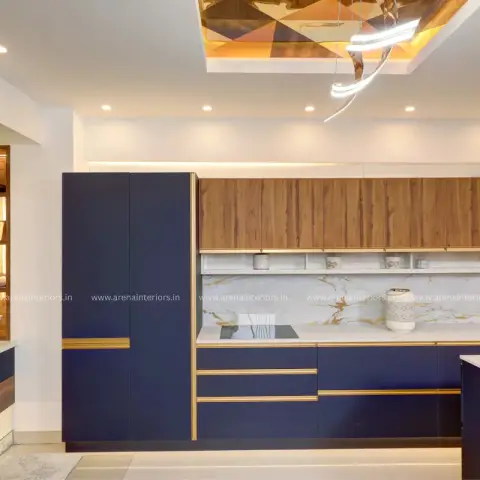 Kitchen with navy-blue and gold-trim cabinetry, a wood-panel upper unit, gold-veined marble backsplash and island counter