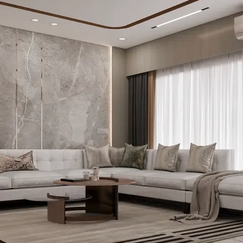 L-shaped grey sofa with an assortment of cushions faces a round wood-and-glass coffee table