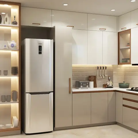 L-shaped ivory gloss modular kitchen with rose-gold tubular handles and a full-height fridge tower