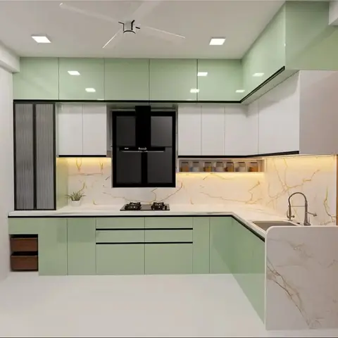 L-shaped mint-green gloss modular kitchen with a gold-veined marble backsplash and a built-in black fridge alcove.