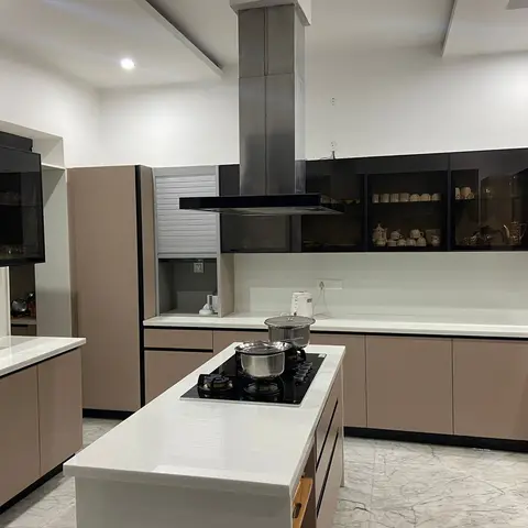 Large U-shaped Indian kitchen with mocha glossy shutters, a black-hob island, and glass-front display cabinets over a marble floor
