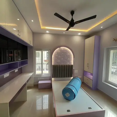Lavender-and-white kids' bedroom under construction, with a wall-mounted TV unit, built-in wardrobe