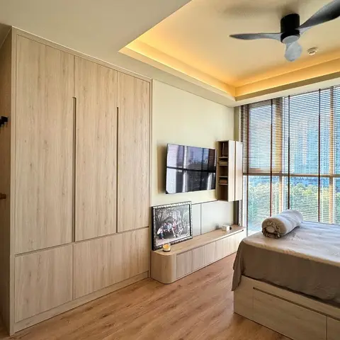 Light-oak bedroom facing a full-height window wall with timber venetian blinds, a drawer-base platform bed and a wall TV over a floating console with an open