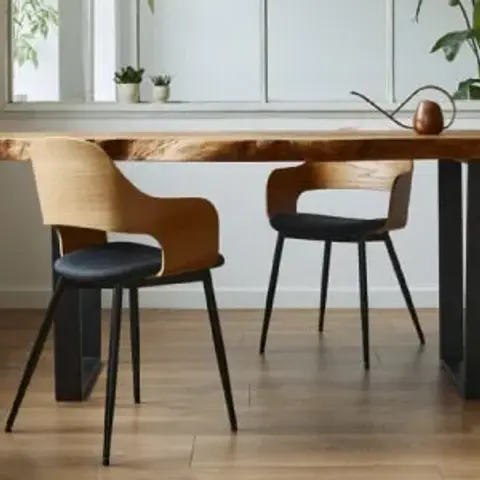 Live-edge solid wood dining slab on black steel trestle legs with three bentwood-and-black-seat chairs, a small wooden bird ornament on the table