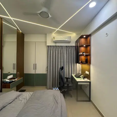Lived-in bedroom where recessed profile lights run in a zigzag across the ceiling