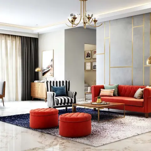 Living room built around a coral tufted three-seater and two round coral poufs, with a black-and-white striped wing chair