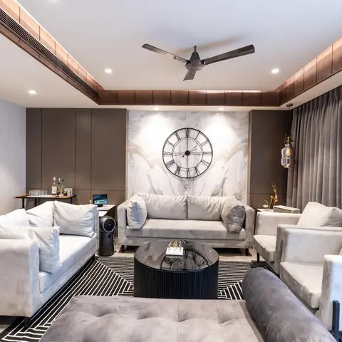 Living room centred on an oversized Roman-numeral wall clock mounted on a marble slab feature wall