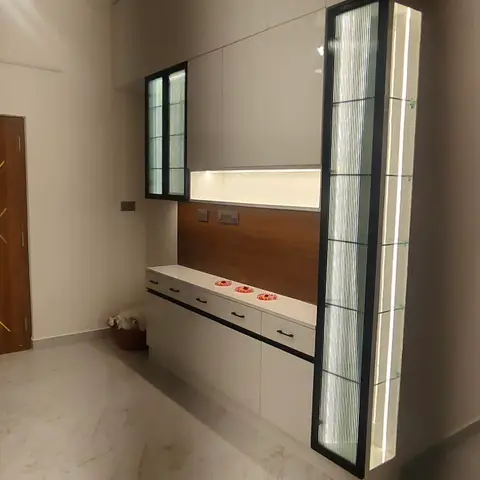 Living room console unit with a backlit fluted-glass display column and wood backpanel above a drawer counter.