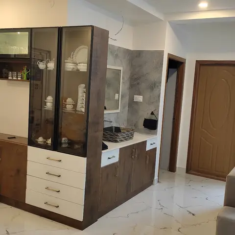 Living room crockery display unit with glass-front upper cabinets, warm wood-grain and white drawer base