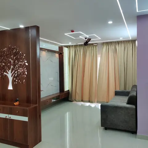 Living room entry with a backlit wood tree-jaali partition beside a marble-clad TV console