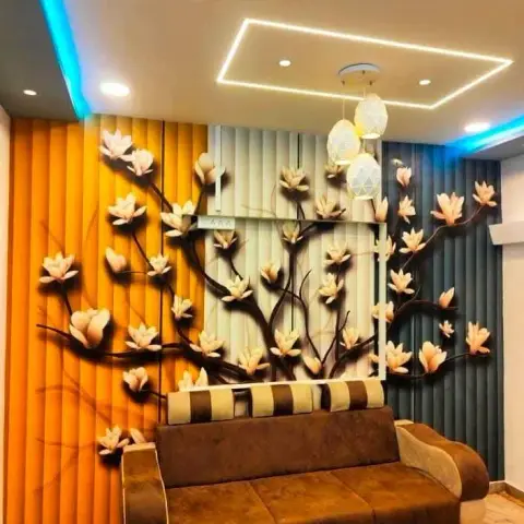Living room feature wall in bold orange-cream-teal fluted panelling with a raised 3D floral tree relief, behind a brown leather sofa.