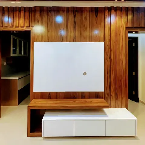 Living room feature wall in fluted wood-grain panelling with a floating TV console and an open ladder-shelf display alcove